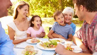 Family enjoying a meal outdoors.