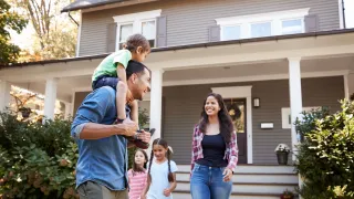 Family walking in front of their home.