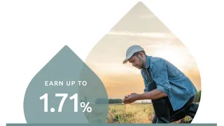 Farmer kneeling in dirt with rate promotion
