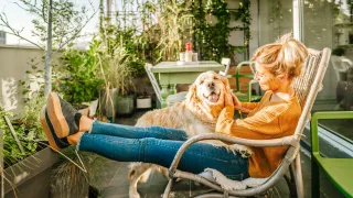 Lady sitting on her porch with her dog