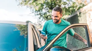 man on phone while getting into vehicle