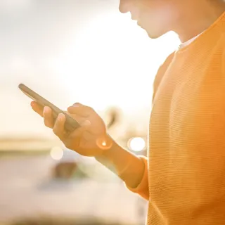 Person holding a phone outdoors